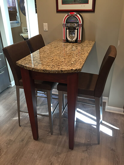 Amisco's Pablo Upholstered Bar Stools in Silver Metal Finish and Brown Cushion in Dining Space